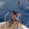 Child entering the ocean from a Catamaran in Tenerife
