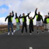 Group of happy people jumping on the Teide road in Tenerife