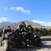 Couple kissing on Mount Teide while sitting on quads