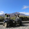 2 people posing on 2 quads with Mount Teide behind them