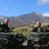 2 people posing on 2 quads with Mount Teide behind them