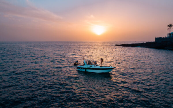 Motorboat on ocean in Tenerife with sunset